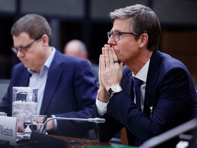 Chairman and president of Loblaw Cos. Ltd. Galen Weston Jr., right, and president and chief executive of Empire Co. Ltd. Michael Medline appear before a committee on Parliament Hill in Ottawa on March 8.