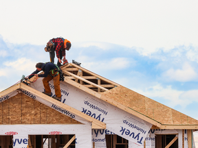 Construction works on the roof of a new home