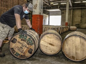 FILE - Green River Distilling Co. employee Coleman Savage looks over the 300,000th barrel of bourbon filled at the distillery inside the new-fill warehouse at the plant on April 20, 2021, in Owensboro, Ky. A proposed tax break for Kentucky's bourbon makers was fast-tracked Monday, March 13, 2023, in advancing in the state House, but local leaders living near some of the world's best-known distilleries were in no mood to toast the industry victory