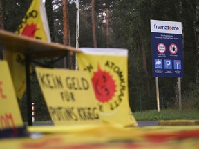 FILE - Protest posters are placed in front of the fuel element fabrication plant of the 'framatome' company in Lingen, Germany, on Sept. 12, 2022. German officials have criticized plans by French firm Framatome to produce nuclear fuel in a joint venture with Russia's Rosatom at a facility in western Germany, and say they will consider whether an application to do so can be rejected.