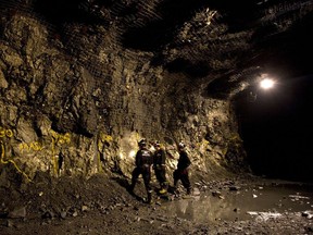 People look over an outcropping of copper and nickel deposits at a mine in Sudbury, Ont.