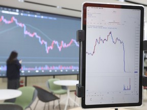 FILE - A screen, right, shows the falling values of the Luna cryptocurrency, at a cryptocurrency exchange in Seoul, South Korea, Friday, May 27, 2022. Police in Montenegro have arrested Terraform Labs founder Do Kwon, who is wanted in South Korea in connection with a $40 billion crash of the firm's cryptocurrency that devastated retail investors around the world, the European country's interior minister said Thursday, March 23, 2023.