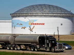 A storage tank looms over a freeway at the Enbridge Inc. Edmonton terminal in Alberta.