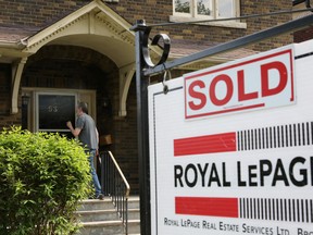 A realtor's 'for sale' sign outside a house that has been sold in Toronto.