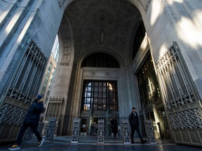 People exit the building where Credit Suisse bank has its headquarters in New York City, U.S.
