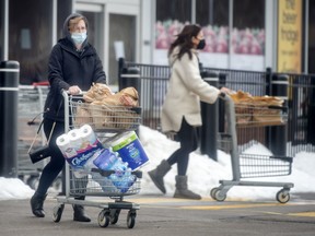 Shoppers leaving Longo’s grocery store in Oakville.