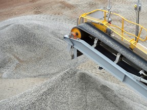 Ore falls from a conveyor onto a stockpile at a lithium mine site.