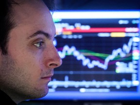 A specialist trader works inside a booth on the floor of the New York Stock Exchange.