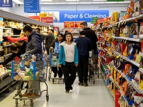 People shop at a Walmart Supercentre in Toronto, Ont.