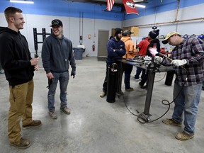 Payton Lane, 19, left, and Boone Williams, 20, talk during a second-year apprentice training program class at the Plumbers and Pipefitters Local Union 572 facility in Nashville, Tenn., on Thursday, Feb. 2, 2023. The union is working with young adults who graduated from high school during the pandemic and are taking career routes other than college for its apprentice program.
