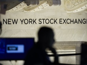 FILE - Traders work on the floor at the New York Stock Exchange in New York, Tuesday, Jan. 24, 2023.