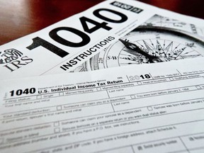 FILE- Internal Revenue Service taxes forms are seen on Feb. 13, 2019. Unlike a deduction, which decreases the income on which you'll be taxed, a tax credit reduces your overall tax due. The result can mean hundreds of dollars knocked off your bill -- or added to your refund.