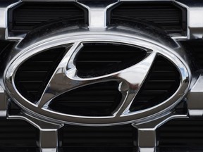 FILE - The Hyundai company logo is displayed Sunday, Sept. 12, 2021, in Littleton, Colo. Hyundai and Kia are telling owners, Friday, March 23, 2023 of over 571,000 SUVs and minivans in the U.S. to park them outdoors because the tow hitch harnesses can catch fire while they are parked or being driven. The Korean automakers are recalling the vehicles.