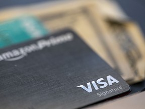 FILE - The Visa logo is seen on a credit card in New Orleans, Aug. 11, 2019. When you have credit card debt, the easiest way to deal with it is to diligently make monthly payments of at least the minimum amount due, and more if your budget allows. In doing this, you avoid late fees and your account is considered in good standing.