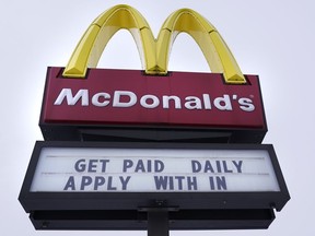 A sign outside a McDonald's restaurant offers prospective workers an opportunity to get paid daily for their employment, Monday, Feb. 27, 2023, in Salem, N.H. On Thursday, the Labor Department reports on job openings and labor turnover for January.