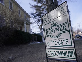 A "For Sale" sign is posted outside a home converted into condominium units, Tuesday, Feb. 7, 2023, in Exeter, N.H. On Thursday, Freddie Mac reports on this week's average U.S. mortgage rates.