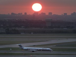 FILE - In this Aug. 26, 2015 file photo, an American Airlines jet taxis on a runway as the the sun rises in the east sky looking from the Dallas-Fort Worth International Airport in Grapevine, Texas. The federal government is spending more money on airport improvements designed to reduce the number of times that planes must taxi across active runways. Transportation Secretary Pete Buttigieg visited Dallas-Fort Worth International Airport on Thursday, March 30, 2023 to announce $29 million in federal money to help build a new taxiway at the nation's second-busiest airport.