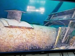 FILE - In this photo provided by the Michigan Department of Environment, Great Lakes, and Energy, footage played on a television screen shows damage to anchor support EP-17-1 on the east leg of the Enbridge Line 5 pipeline within the Straits of Mackinac, Mich., in June 2020. A federal review of plans for the Great Lakes oil pipeline tunnel will take more than a year longer than originally planned, officials said Thursday, March 23, 2023, likely delaying completion of the project -- if approved -- until 2030 or later. (Michigan Department of Environment, Great Lakes, and Energy via AP, File)