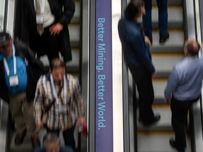 People use an escalator at PDAC in Toronto, on March 6.