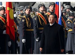 Xi Jinping walks past an honour guard during a welcoming ceremony at Vnukovo airport, Moscow, on March 20. Photographer: Anatoliy Zhdanov/AFP/Getty Images