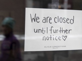 A sign on a shop window indicates the store is closed in Ottawa, Monday March 23, 2020. The Office of the Superintendent of Bankruptcy says the total number of insolvencies in Canada in January was up by roughly a third compared with a year earlier.