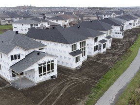In this photo taken using a drone, homes under construction are seen in a new suburb, Friday, Oct. 15, 2021 in Ottawa. First proposed in the federal government's 2022 budget, the Tax-Free First Home Savings Account comes into force April 1, allowing prospective homebuyers who have never owned a home to save up to $40,000 on a tax-free basis.