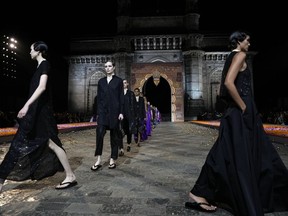 Models display creations for the Dior Pre-Fall 2023 collection at the Gateway of India landmark monument in Mumbai, India, Thursday, March 30, 2023.