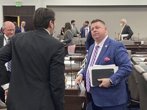 State Rep. Jason Saine, right, R-Lincoln, speaks with Rep. Terence Everitt, D-Wake, after a House Commerce Committee at the Legislative Office Building on Tuesday, March, 21, 2023, in Raleigh, N.C. Saine is a chief sponsor of a sports wagering bill that was approved by the committee on Tuesday.
