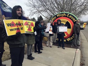 FILE - Brendan Shaughnessy, left, with the Nuclear Issues Study Group, protests with other activists ahead of a meeting of a U.S. Nuclear Regulatory Commission panel in Albuquerque, N.M., on Tuesday, Jan. 22, 2019. Lawmakers have endorsed a measure that calls for banning the storage of spent nuclear fuel in N.M., unless the state provides its consent first. Democratic lawmakers have been raising concerns that opening the door to waste from commercial nuclear power plants around the U.S. would result in New Mexico becoming the nation's dumping ground. The legislation passed the House on Friday, March 17, 2023, and governor intends to sign it.
