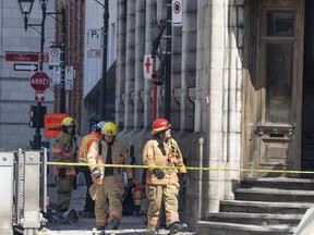 Firefighters continue the search for victims Monday, March 20, 2023 at the scene of last week's fire that left one person dead and six people missing in Montreal. A deadly fire that swept through a building in Old Montreal on Thursday where several apartments were being used as Airbnb units is raising safety concerns about short-term rental properties.