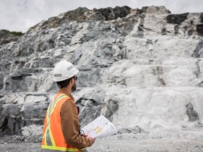 An employee of Sayona Quebec in front of a lithium deposit at the company's North American Lithium Complex in La Corne, central Quebec.
