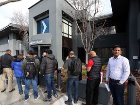 People line up outside of a Silicon Valley Bank office on March 13 to try to retrieve their deposits in Santa Clara, California, days after the bank collapsed.
