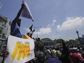 FILE - Sri Lankans shout slogans during a protest against the government increasing income tax to manage day to day expenses amid an unprecedented economic crisis in Colombo, Sri Lanka, on Feb. 22, 2023. The International Monetary Fund said Monday, March 21, that its executive board has approved a nearly $3 billion bailout program for Sri Lanka over four years to help salvage the country's bankrupt economy.