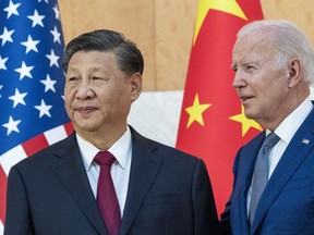 FILE - U.S. President Joe Biden, right, stands with Chinese President Xi Jinping before a meeting on the sidelines of the G20 summit meeting on Nov. 14, 2022, in Bali, Indonesia. Xi accused Washington on Monday, March 6, 2023, trying to isolate his country and hold back its development. That reflects the ruling Communist Party's growing frustration that its pursuit of prosperity and global influence is threatened by U.S. restrictions on access to technology, its support for Taiwan and other moves seen by Beijing as hostile.