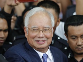 FILE - Former Malaysian Prime Minister Najib Razak gets into a car after his court appearance at the Kuala Lumpur High Court in Kuala Lumpur, Malaysia, on April 3, 2019. Malaysia's top court refused Friday, March 31, 2023 to review its decision last year to uphold former Prime Minister Najib Razak's conviction for graft and 12-year jail sentence, saying he was "the author of his own misfortune."