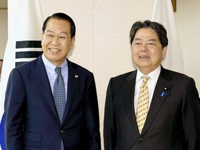 South Korean Unification Minister Kwon Youngse, left, and Japanese Foreign Minister Yoshimasa Hayashi pose for a photo at foreign ministry in Tokyo Thursday, March 27, 2023. Senior South Korean and Japanese government officials reaffirmed their close cooperation in response to North Korea's escalating missile threats at a rare meeting on Thursday, a sign of a further thaw in their relations that came only a week after their leaders agreed to overcome their troubled history and mend ties so they can better respond together to growing regional threats. (Kyodo News via AP)