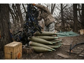 A Ukrainian serviceman prepares 155mm artillery shells near Bakhmut, Ukraine. Photographer: Aris Messinis/AFP/Getty Images