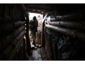 A Ukrainian soldier walks into a dugout on the front line near Bakhmut, Donetsk region on February 21. Photographer: Anatolii Stepanov/AFP/Getty Images