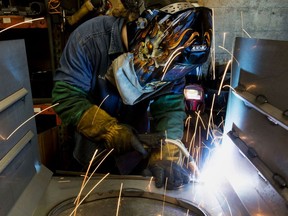 A worker uses a mig welder at a coal stove manufacturing facility in Berwick, Pa.