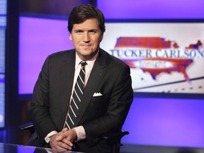 FILE - Tucker Carlson, host of "Tucker Carlson Tonight," poses for photos in a Fox News Channel studio on March 2, 2017, in New York. The lawyer for a one-time supporter of former President Donald Trump who has been caught up in a Jan. 6 conspiracy theory demanded Thursday that Fox News and host Tucker Carlson retract and apologize for repeated "falsehoods" about the man's supposed intentions.