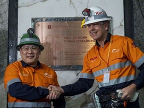 IIn this photo released by Rio Tinto, Mongolian Prime Minister Luvsannamsrain Oyun-Erdene, left, shakes hands with Rio Tinto's Chief Executive Jakob Stausholm during the start of underground production at the Oyu Tolgoi mine in Khanbogd village, Umnugobi province, Mongolia Monday, March 13, 2023. Mongolia plans to channel revenue from rising copper exports into an economic development fund to reap more benefit from its mineral riches and root out corruption, the North Asian nation's prime minister said Tuesday, following the opening of a major expansion of its biggest mine. (Rio Tinto via AP)
