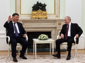 Chinese President Xi Jinping gestures while speaking to Russian President Vladimir Putin during their meeting at the Kremlin in Moscow, Russia, Monday, March 20, 2023.