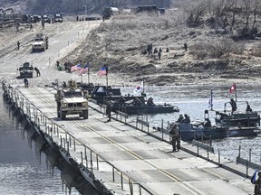 In this photo provided by the South Korea Defense Ministry, South Korea and U.S. militaries conduct a joint river-crossing drill in Yeoncheon, South Korea, Monday, March 13, 2023. South Korea's president wants Japan to join his efforts to improve ties frayed over Tokyo's past colonial rule, saying there is an increasing need for greater bilateral cooperation because of North Korean nuclear threats and global supply chain challenges. (South Korea Defense Ministry via AP)