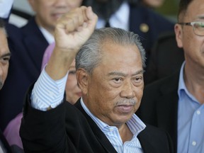Malaysia's former Prime Minister Muhyiddin Yassin poses for media outside courthouse, after charged with corruption and money laundering, in Kuala Lumpur, Malaysia, Friday, March 10, 2023. Muhyiddin has been charged with corruption and money laundering, making him Malaysia's second ex-leader to be indicted after leaving office. Muhyiddin pleaded innocent Friday to four charges of corruption and two charges of money laundering.
