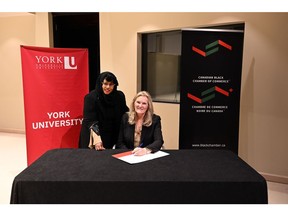 Executive Director of Canadian Black Chamber of Commerce Jamila Ama (left) and York University President and Vice-Chancellor Rhonda Lenton (right) sign a Memorandum of Understanding to create positive change for Black-owned businesses and social enterprises by reducing barriers to commerce and driving inclusive economic growth.