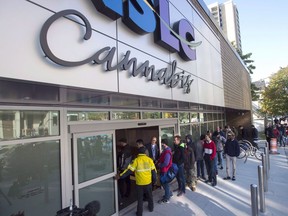 Customers enter the Nova Scotia Liquor Corporation cannabis store in Halifax on Oct. 17, 2018. A spate of cannabis store robberies has many in the industry calling for provinces to relax regulations requiring window coverings or cannabis to be kept out of sight of minors.