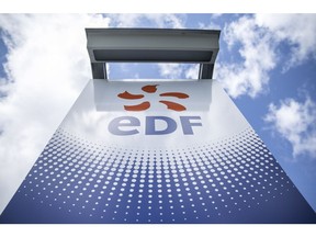 An EDF logo sits on a sign outside a hydroelectric power plant operated by Electricite de France SA (EDF), in Bort-les-Orgues, France, on Tuesday, May 13, 2014. Photographer: Balint Porneczi