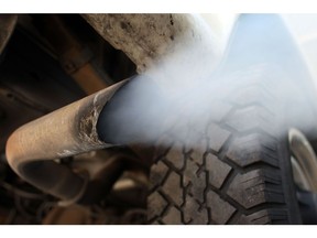 MIAMI - JULY 11: Exhaust flows out of the tailpipe of a vehicle at , "Mufflers 4 Less", July 11, 2007 in Miami, Florida. Florida Governor Charlie Crist plans on adopting California's tough car-pollution standards for reducing greenhouse gases under executive orders he plans to sign Friday in Miami.