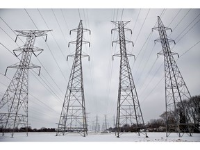 Transmission towers stand near the NRG Energy Inc. Will County Generating Station, a coal-fired power plant, in Romeoville, Illinois, U.S., on Monday, Jan. 8, 2018. The White House's plan to bail out America's coal country has been shot down -- by the very energy regulators that President Donald Trump appointed last year. Photographer: Daniel Acker/Bloomberg