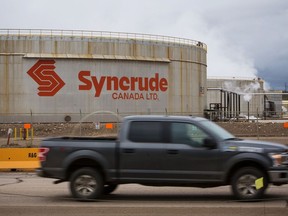A truck drives past the Syncrude Canada Ltd. facility in the Athabasca oil sands near Fort McMurray, Alberta, Canada, on Sunday, Sept. 9, 2018. New technologies such as driverless trucks and froth-treatments that eliminate the need for multibillion-dollar upgraders -- along with U.S. benchmark crude prices closer to $70 -- are helping make the industry profitable again.